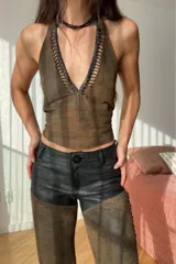 Pantalón de cuero ovino vintage marrón y negro con corte texano y flecos.