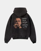 Canguro con capucha de calce regular, confeccionado en tejido con efecto lavado stone wash. Presenta un estampado gráfico en la espalda inspirado en la película Trainspotting, con el rostro de un personaje y la frase 'Choose your future, choose life'. Cuenta con puños y cintura acanalados.