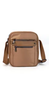 Morral bandolera color lila con correa ajustable, dos bolsillos frontales con cierre y dos bolsillos internos.