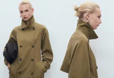Abrigo tipo trench de diseño recto y oversize, color verde oliva. Presenta cierre de doble botonadura, cuello de solapa ancha, bolsillos laterales y mangas largas con puños abotonados. Incluye forro interior y cinturón desmontable.