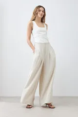 Pantalón palazzo color beige melange de tiro alto con pinzas delanteras y corte amplio.