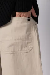 Pantalon de corte baggy con diseño amplio y relajado, confeccionado en gabardina color tostado.