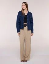 Campera de jean blanca de corte clásico, con cuello solapa, cierre frontal de botones metálicos y bolsillos aplicados con solapa en el pecho.