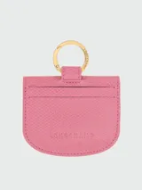 Tarjetero de cuero rosado Longchamp modelo Les Champions Epure, con argolla metálica dorada, dos botones a presión grabados y diseño de corazón bordado en el frente.