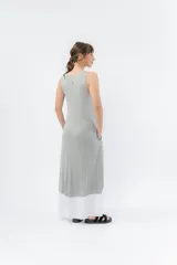 Vestido largo negro con base blanca, de corte suelto y sin mangas.