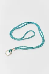 Correa para celular o accesorios, recubierta de cristales rosados, con terminal y argolla metálica en tono plateado.