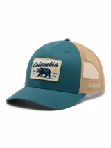 Gorro trucker Columbia de color verde azulado y beige, con paneles de malla trasera y un parche frontal estampado con un oso y la marca.