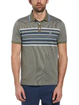 Polo de piqué color verde oliva con diseño jacquard. Presenta cuello clásico con borde celeste, tapeta de dos botones y mangas cortas con borde a tono. Tiene un bloque central con rayas horizontales en tonos verde, azul y blanco.