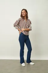 Jean de corte oxford en color negro, con tiro medio y ajuste en la cintura y caderas, ensanchándose desde la rodilla hacia el ruedo.