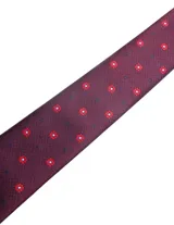 Corbata de seda azul marino con estampado paisley en tonos rosados y blancos.