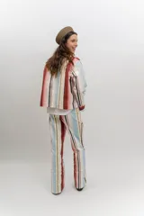 Chaqueta liviana de jean celeste con cuello mao, cierre frontal con alamares y detalle de bordados florales.