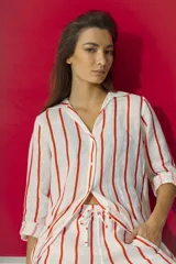 Camisa de lino blanca con rayas verticales rojas, de calce relajado, cuello camisero y mangas largas.