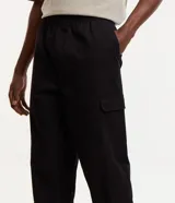 Pantalón jogger negro de sarga de algodón y elastano, con bolsillos cargo laterales y tobillos ajustados.