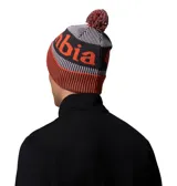 Gorro de lana con pompón, diseño tejido con franjas en gris y naranja, y logo de la marca estampado en el frente. Cuenta con forro térmico interno para mayor retención de calor.