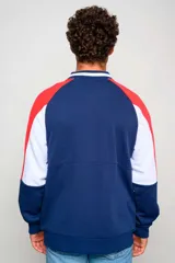 Campera bomber Umbro del Club Nacional de Football, color azul marino con diseño tricolor en las mangas con rojo y blanco, cuello tipo rib con rayas, y cierre frontal completo.