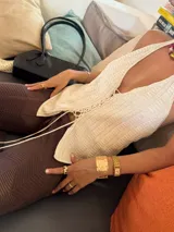 Top negro de tejido de punto con escote halter y lazada frontal ajustable. Presenta un diseño ajustado al cuerpo.