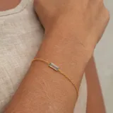 Pulsera dorada de plata 925 bañada en oro 18k, con piedra rectangular de topacio azul y otro topacio azul en el broche.