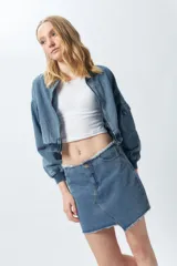 Minifalda de jean negra con corte asimétrico en el frente y deflecado tanto en la cintura como en el ruedo.