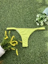 Conjunto de bikini color lima con textura, compuesto por un top triangular con detalle de hebilla metálica plateada en el centro y bombacha colaless.