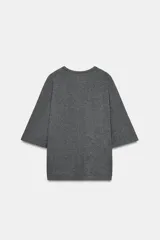 Remera oversize gris melange de tejido fluido, con cuello redondo y mangas cortas amplias.