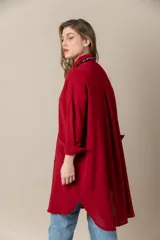 Camisa larga color rojo, de seda poliéster, con cuello clásico, cierre frontal con botones, mangas largas y bolsillos grandes.