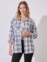 Sobrecamisa cuadrillé blanca y negra con cuello con solapa, abertura central con botones, bolsillos aplicados y mangas largas regulables con presilla y botón. Terminación de ruedo desflecado.