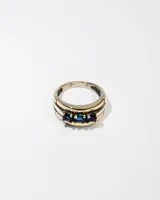 Anillo de plata 925 con dublé de oro y tres zirconias azules.