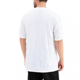 Remera negra de corte holgado con textura arrugada y logo de Puma estampado en el pecho.