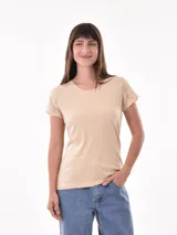 Remera de manga corta color beige claro, con cuello redondo y detalles de bordado tipo ojal (broderie) en las mangas.