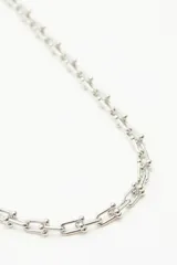 Collar de cadena de metal plateado con eslabones de diseño rectangular y esferas decorativas en las uniones.