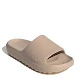 Chanclas de mujer Adidas Adilette Lumia, tipo slide de una sola pieza en color beige, con diseño ergonómico, suela con ranuras flexibles y logo de la marca grabado en el lateral.