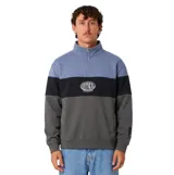Buzo canguro con medio cierre de felpa cepillada, diseño de bloques de color en tonos celeste, negro y gris oscuro, con logo impreso en el pecho y calce oversize.
