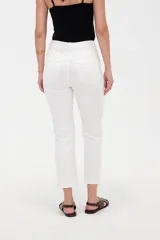 Pantalón jean de tiro alto y corte recto, color blanco, con bolsillos laterales y traseros, y terminación desmechada en los tobillos.