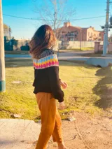 Sweater de punto grueso color negro con diseño geométrico multicolor en el pecho y cuello. Tejido a mano.