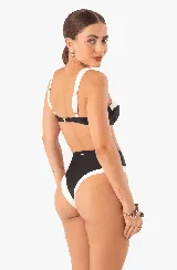 Conjunto de bikini marrón con detalles en blanco. El corpiño es de corte clásico con breteles anchos y la bombacha es de tiro alto con laterales cavados.