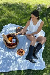 Bota de caña media estilo cowboy, color marrón oscuro con efecto envejecido. Presenta bordados florales en relieve en la caña y puntera afilada. Posee un tacón ancho y bajo.