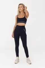 Calza larga de lycra negra con cintura alta y vivos blancos en la parte posterior.