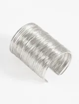 Pulsera rígida plateada para brazo, con diseño de alambre enrollado y abertura ajustable.