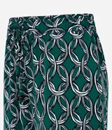 Pantalón largo de crepé con estampado de cadenas en tonos verde, blanco y negro. Tiene cintura elástica con lazo ajustable.