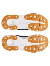 Championes Under Armour modelo Infinite MVMNT, color negro con entresuela blanca y suela de goma color caramelo. Presentan un diseño de materiales mixtos con malla transpirable, tecnología de amortiguación UA HOVR+ y lengüeta de Ariaprene.