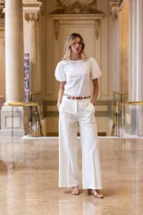 Pantalón blanco de sarga sastrera, de pierna recta y ancha, con bolsillos laterales en la parte delantera y pinza de ajuste en la espalda.