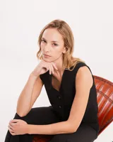 Chaleco de vestir gris oscuro con textura tipo tweed, escote en V y botones frontales. Corte levemente entallado y largo a la cintura.