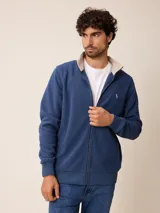 Campera de polar azul con cierre frontal completo, cuello alto en contraste color beige y logo bordado en el pecho.