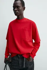 Remera de corte relajado confeccionada en tejido compacto de mezcla de algodón con elasticidad. Presenta cuello redondo, manga corta y un bolsillo frontal de plastrón.