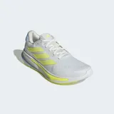 Championes de running Adidas Supernova Ease, color blanco con detalles en amarillo flúor y celeste. Presentan tres franjas laterales en amarillo flúor y mediasuela con tecnología Dreamstrike+.