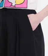 Short blanco de viscosa texturizada, modelo holgado con cintura de sastrería en el frente y elástico en la parte trasera. Presenta bolsillos laterales y cierre con botón y cremallera.