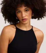 Body blanco sin mangas, confeccionado en tejido rib con textura acanalada y escote recto.