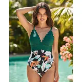 Malla enteriza con diseño combinado, parte superior en color verde petróleo con borde festoneado y parte inferior con estampado floral sobre fondo negro.