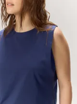 Remera sin mangas de corte relajado, color azul marino, con escote redondo y sutil bordado en el hombro.