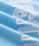 Remera de algodón color celeste con cuello redondo y bordes de mangas en color blanco. Presenta la palabra 'ARGENTINA' estampada en el pecho con tipografía blanca.